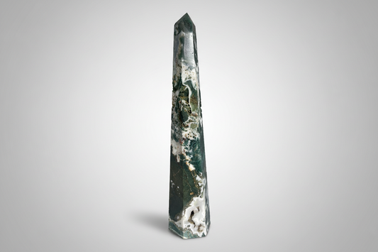 Tall, green crystal obelisk on a white background